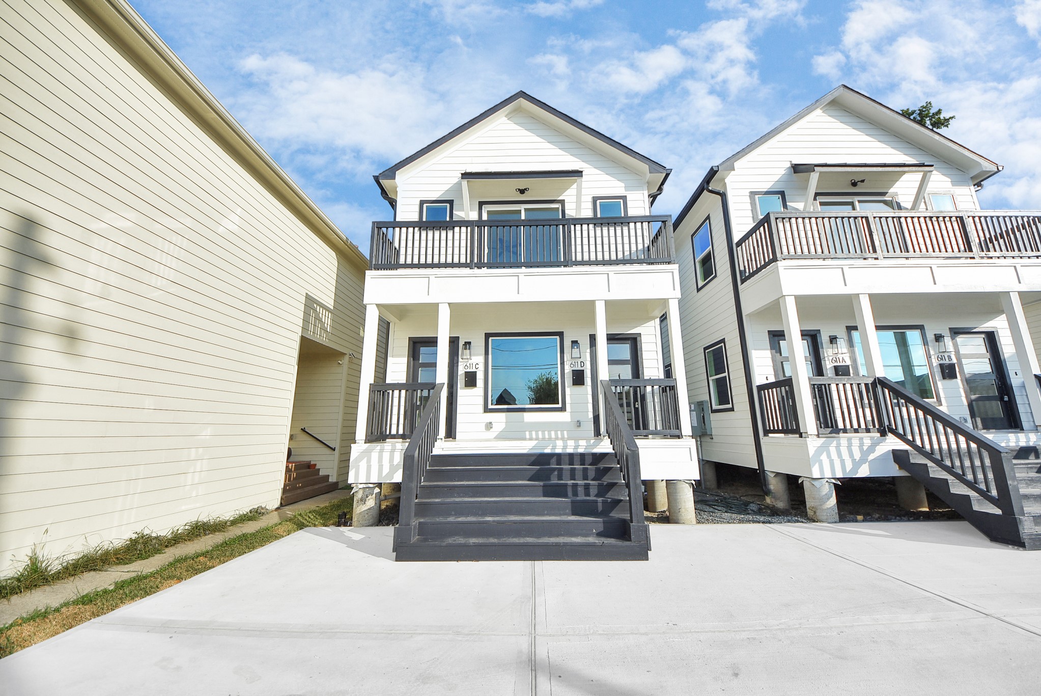 611 East 39th Street, Unit D Houston, TX 77022 - Photo 1 of 33 a view of a white house with large windows and a yard
