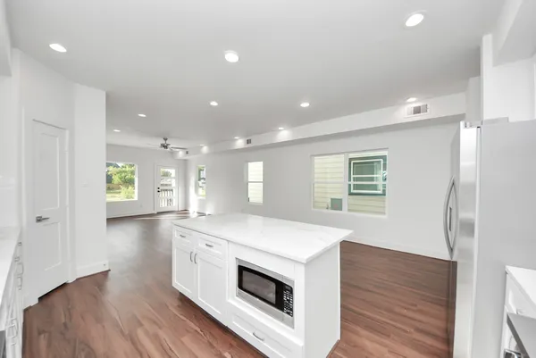 a kitchen with a sink stove and cabinets
