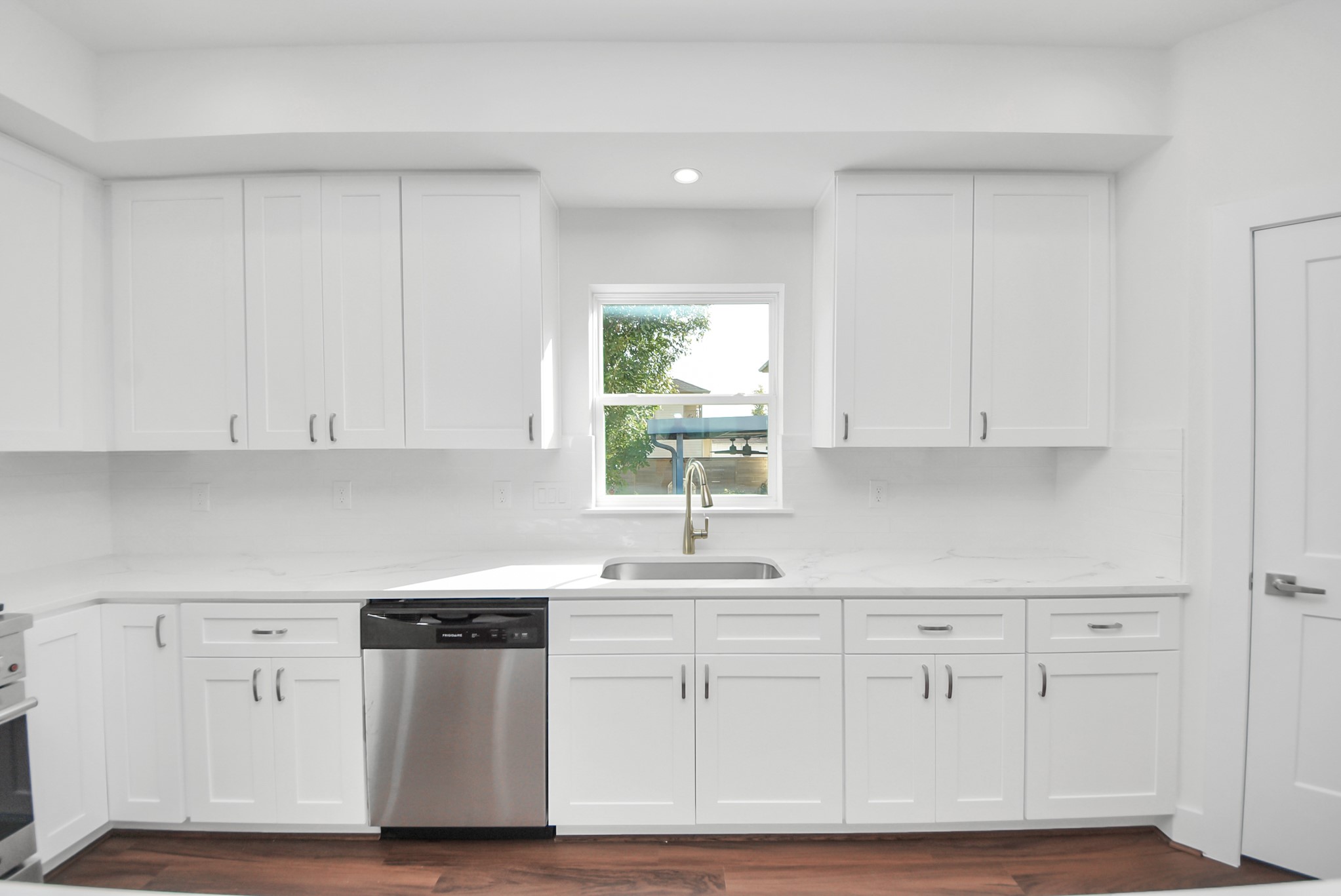 611 East 39th Street, Unit D Houston, TX 77022 - Photo 14 of 33 a kitchen with white cabinets white stainless steel appliances and sink
