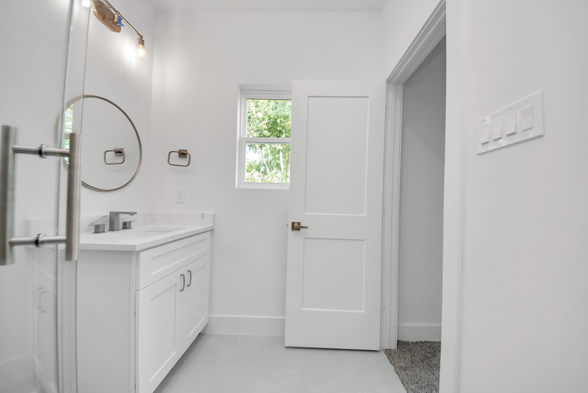 611 East 39th Street, Unit D Houston, TX 77022 - Photo 27 of 33 a spacious bathroom with a granite countertop sink a mirror and shower