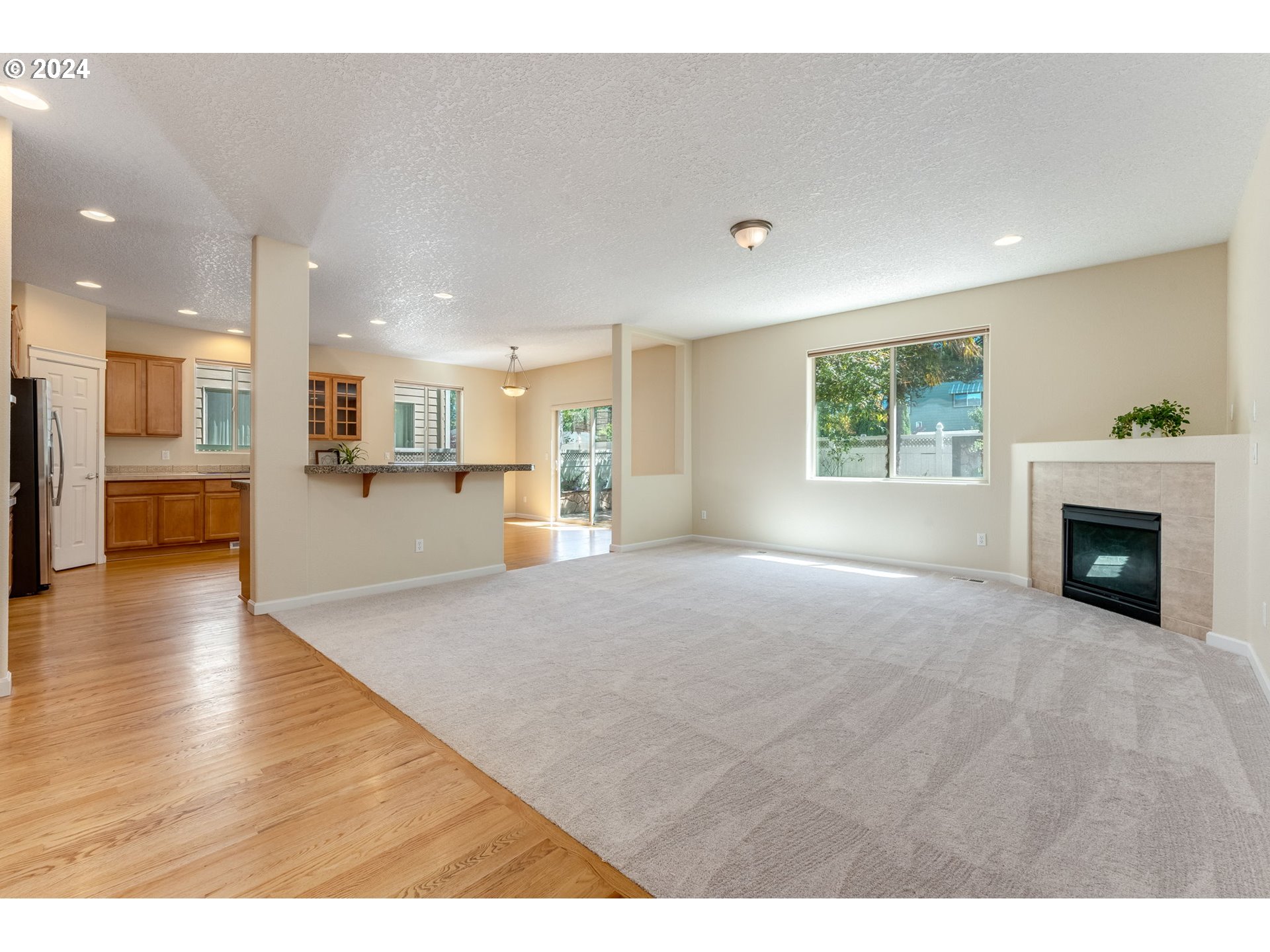 768 North 28th Avenue Cornelius, OR 97113 - Photo 12 of 40 a view of a living room a kitchen and a fireplace