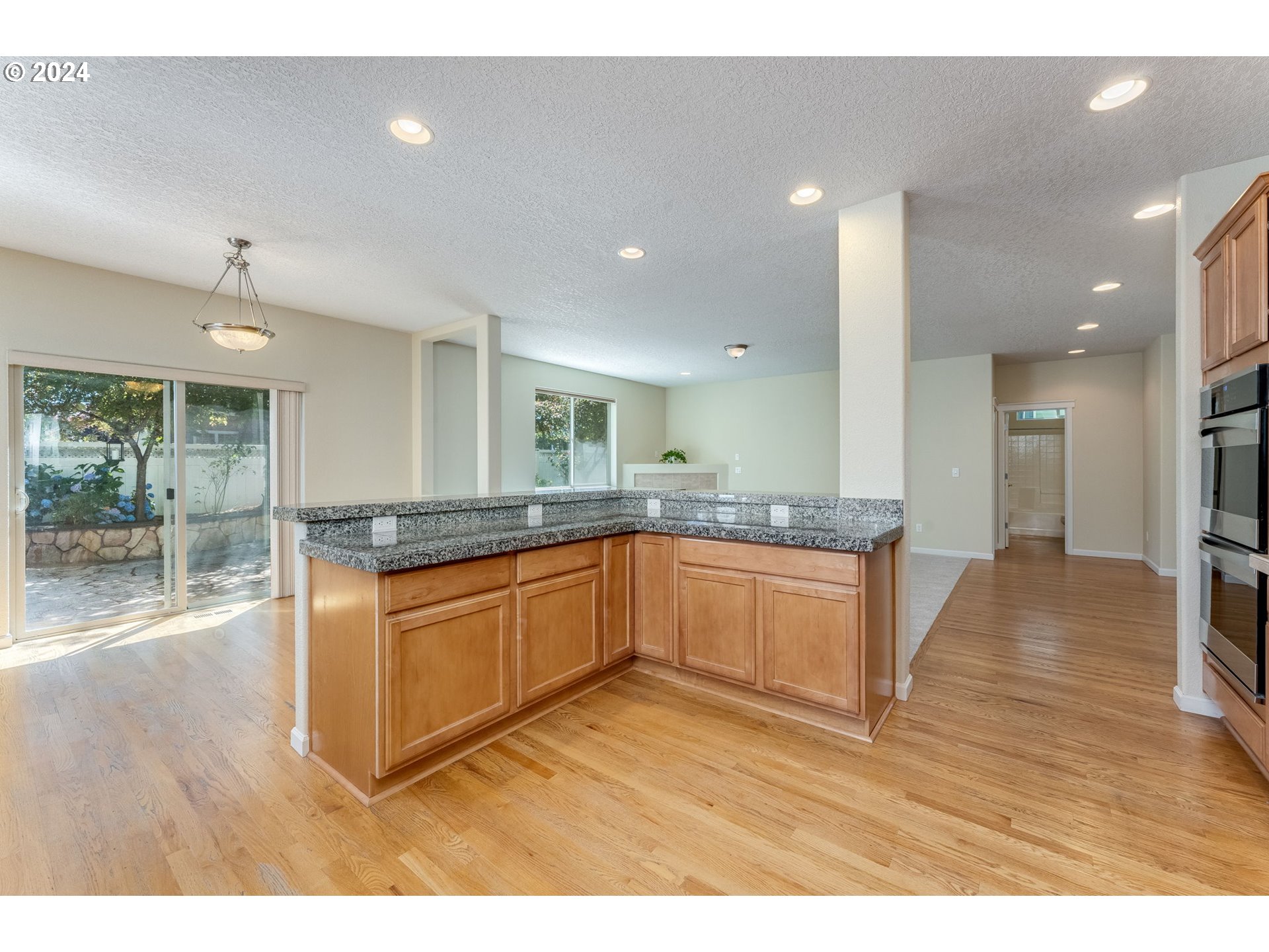 768 North 28th Avenue Cornelius, OR 97113 - Photo 15 of 40 a large kitchen with granite countertop a large counter top and stainless steel appliances
