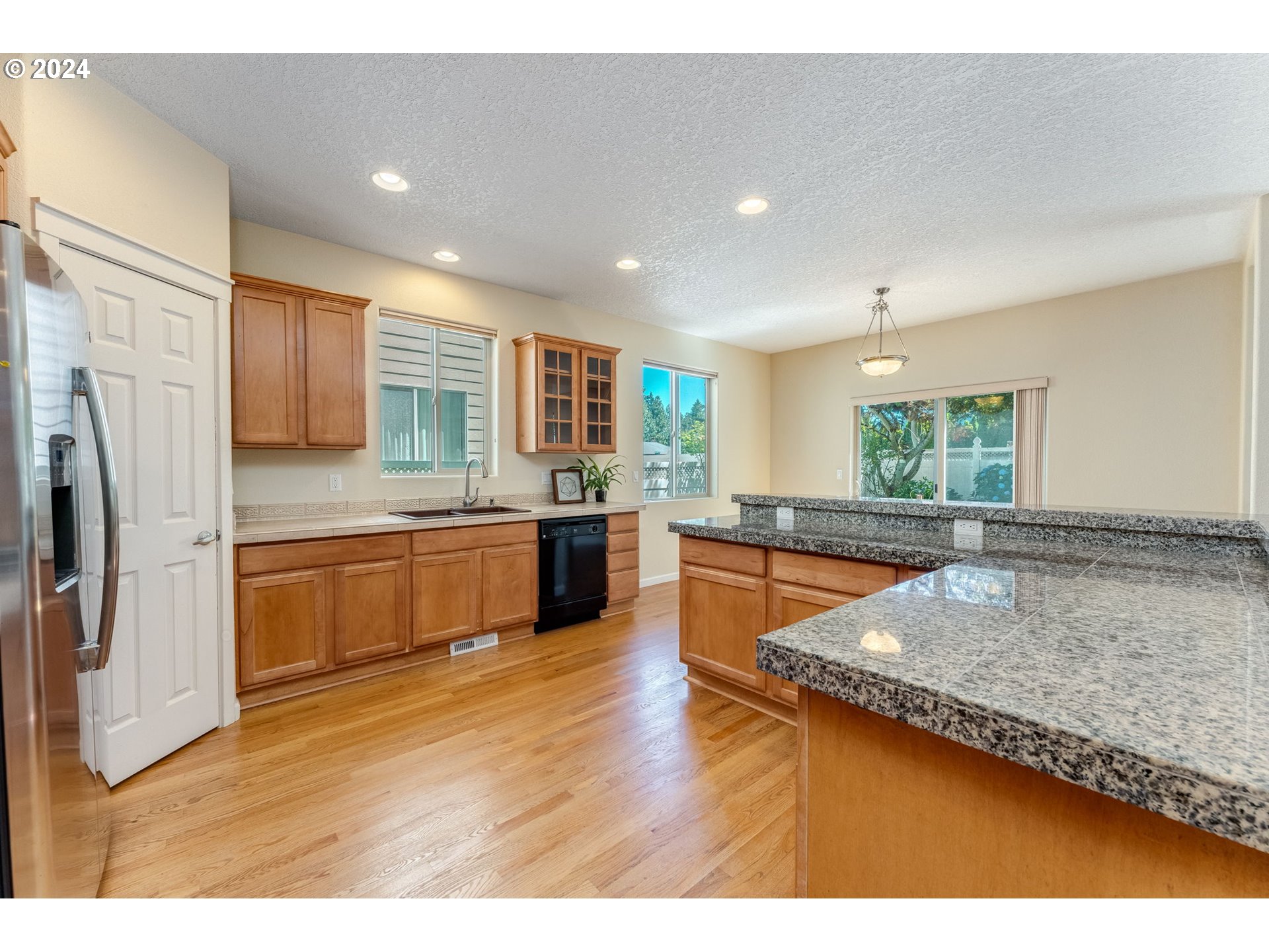 768 North 28th Avenue Cornelius, OR 97113 - Photo 16 of 40 a large kitchen with a counter top space a sink stainless steel appliances and cabinets