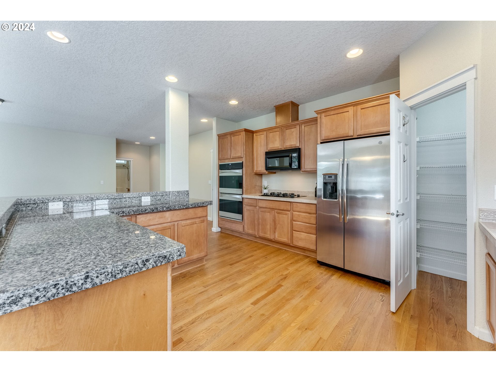 768 North 28th Avenue Cornelius, OR 97113 - Photo 17 of 40 a kitchen with stainless steel appliances granite countertop a refrigerator a sink a stove and oven