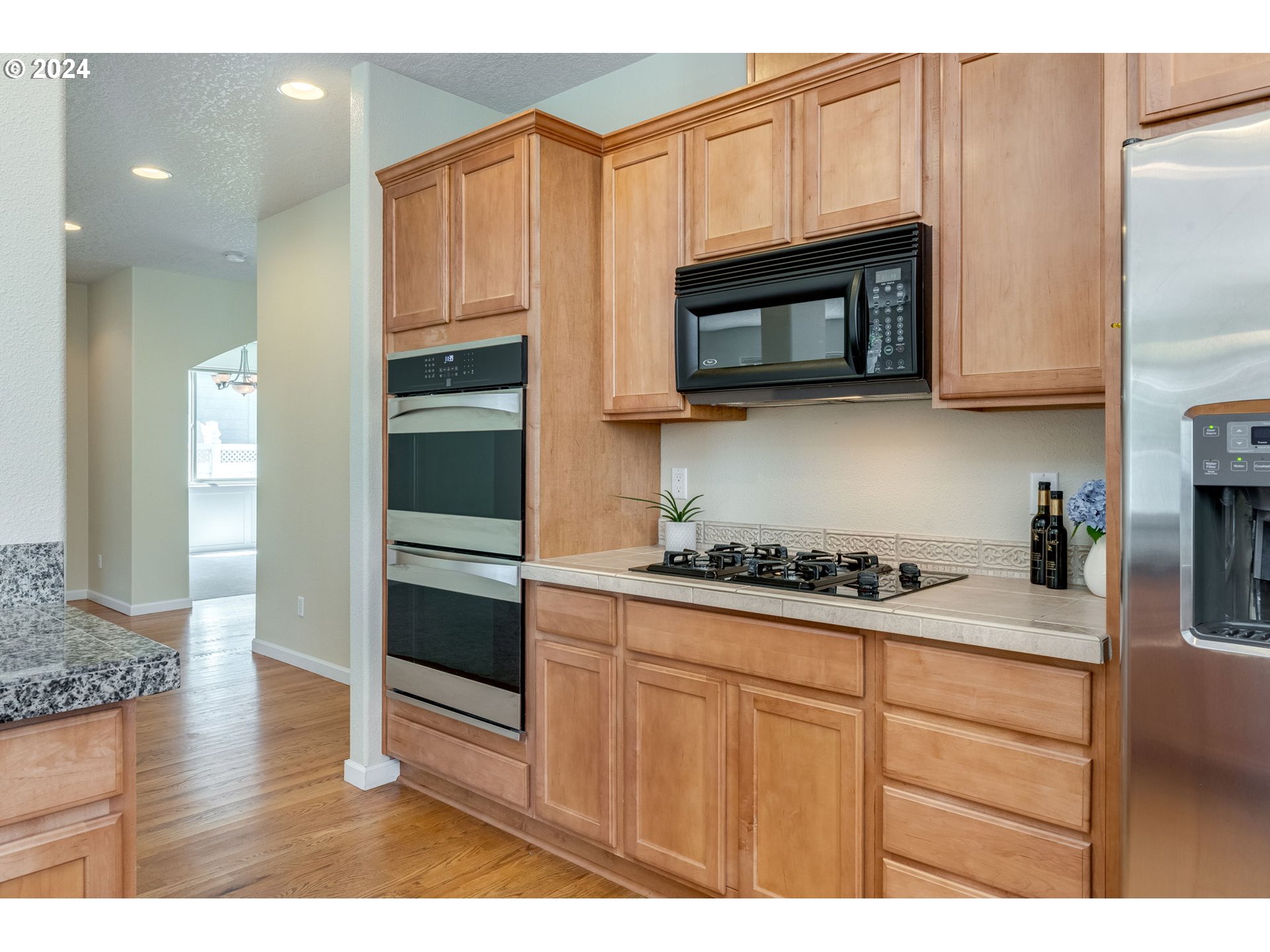 768 North 28th Avenue Cornelius, OR 97113 - Photo 18 of 40 a kitchen with stainless steel appliances granite countertop a stove a microwave and cabinets