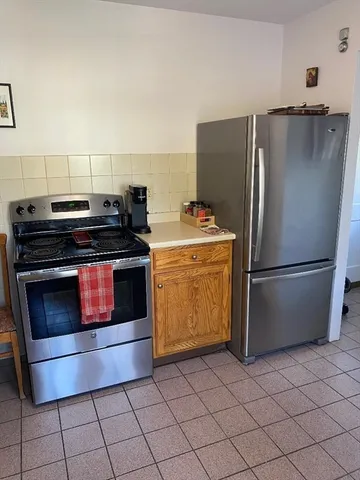 a kitchen with appliances and cabinets