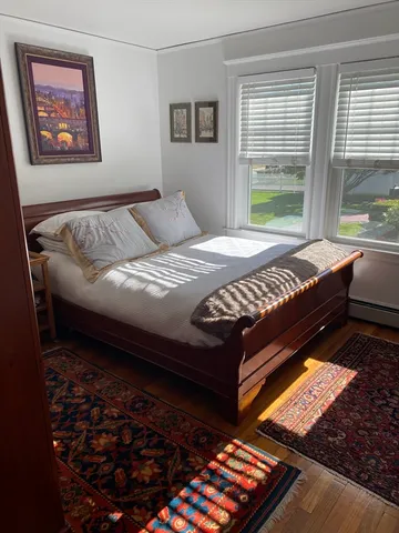 a bed sitting in a bedroom next to a window
