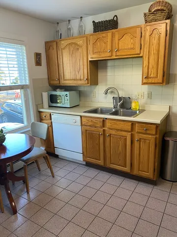 a kitchen with a sink cabinets and window