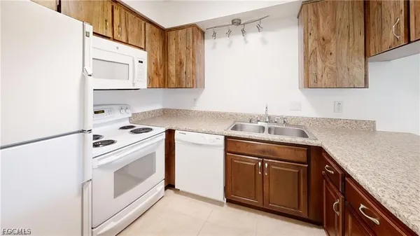 a kitchen with cabinets appliances and a sink