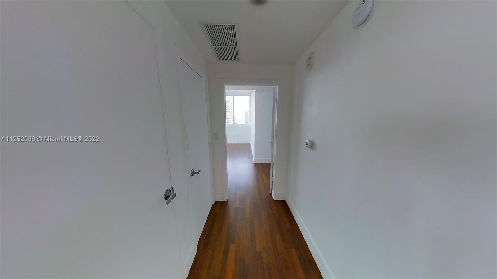 244 Biscayne Boulevard, Unit 4503 Miami, FL 33132 - Photo 20 of 33 a view of a hallway with wooden floor
