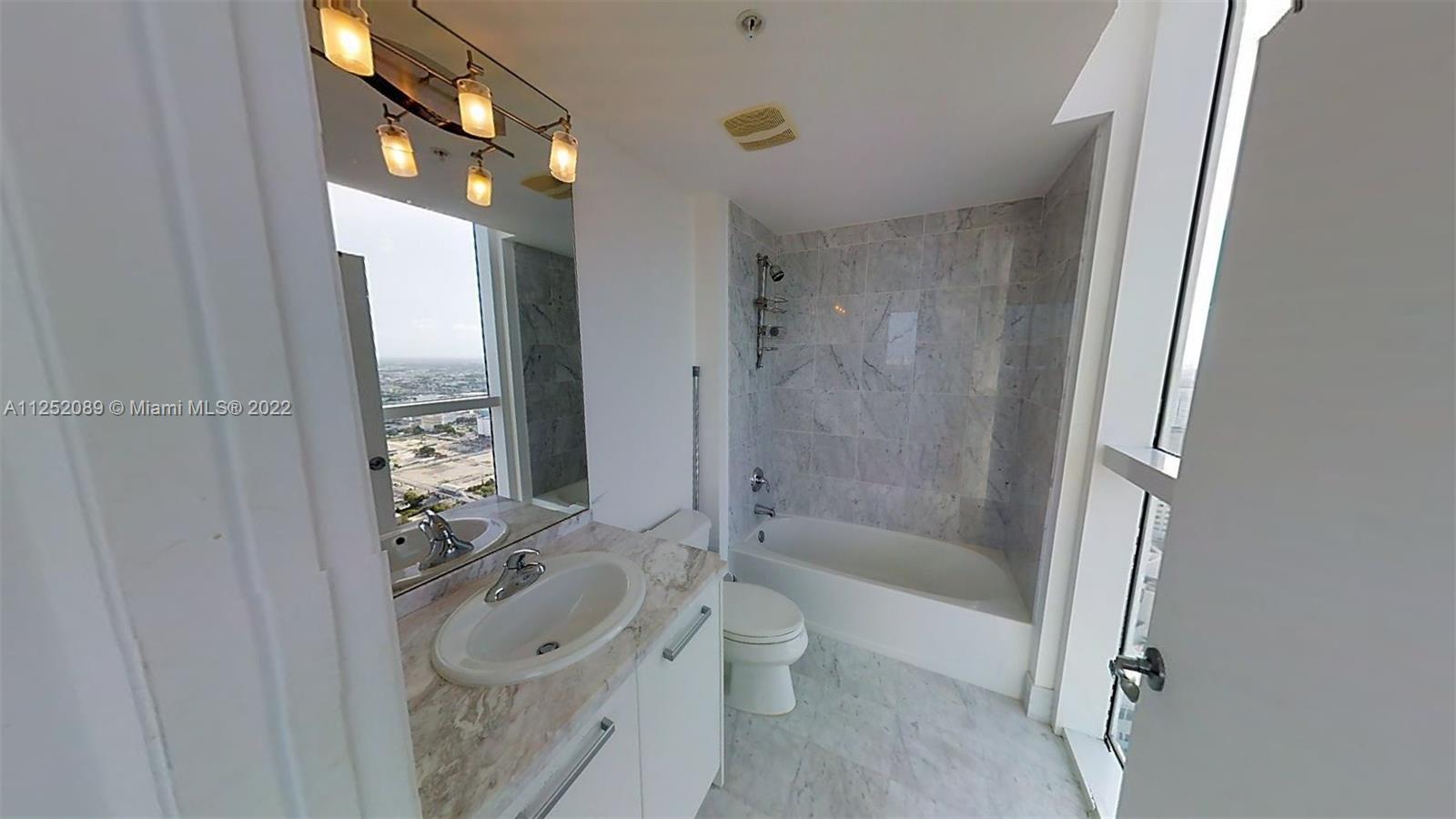 244 Biscayne Boulevard, Unit 4503 Miami, FL 33132 - Photo 33 of 33 a bathroom with a sink a toilet and shower
