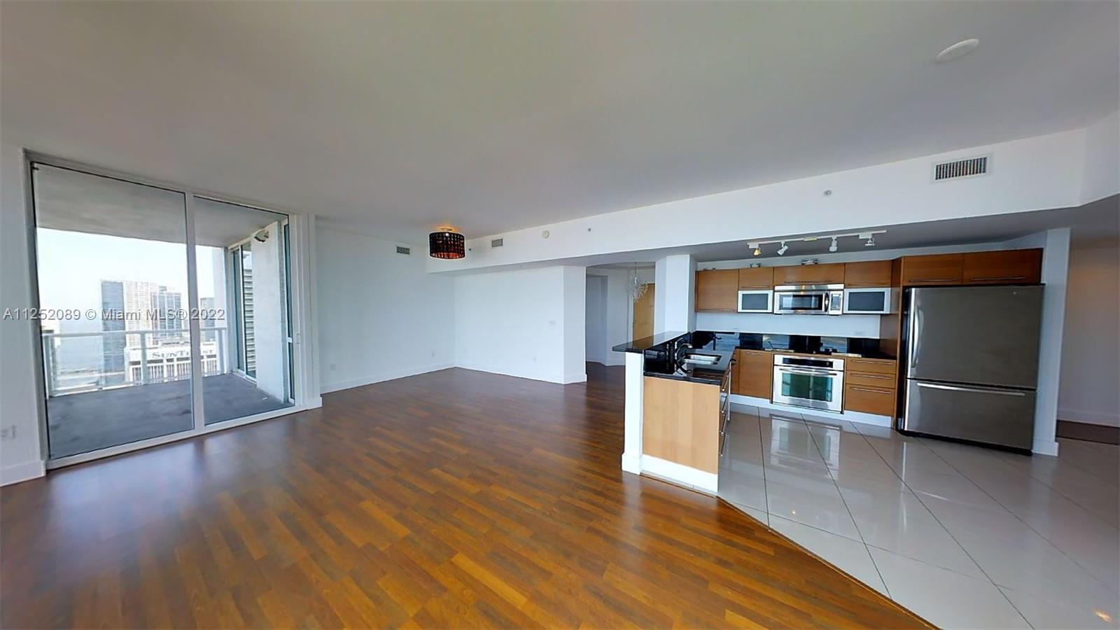 244 Biscayne Boulevard, Unit 4503 Miami, FL 33132 - Photo 5 of 33 a living room with stainless steel appliances kitchen island hardwood floor and a large window