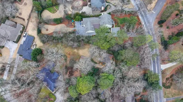 an aerial view of a house with a yard