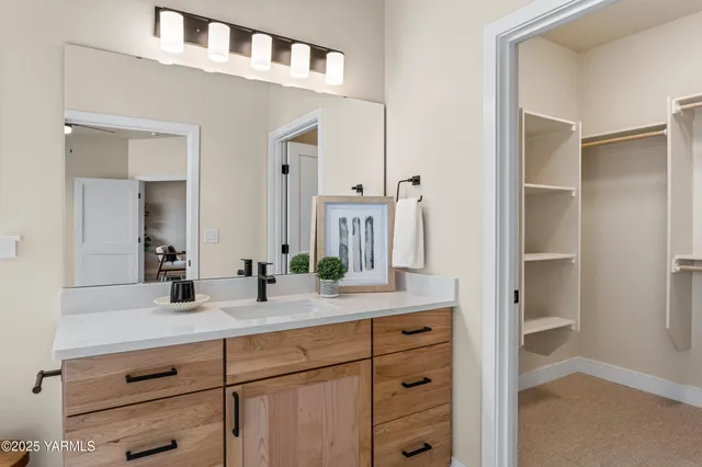 a bathroom with a double vanity sink and mirror