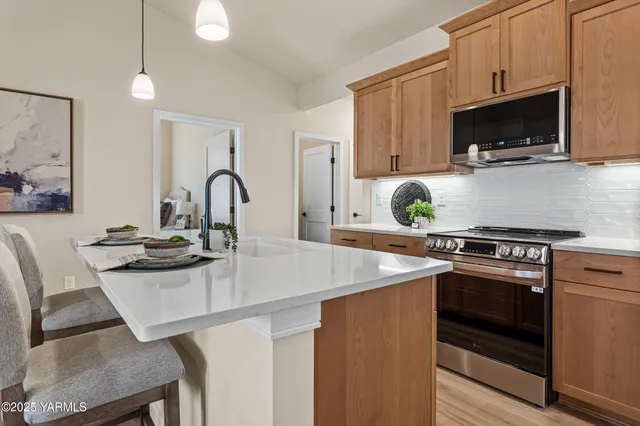 a kitchen with a stove a sink and a microwave