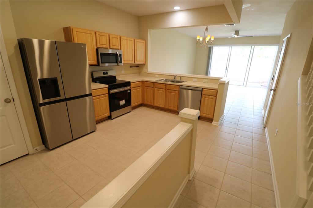 4866 Pond Ridge Drive Riverview, FL 33578 - Photo 11 of 38 a kitchen with stainless steel appliances a refrigerator sink and microwave