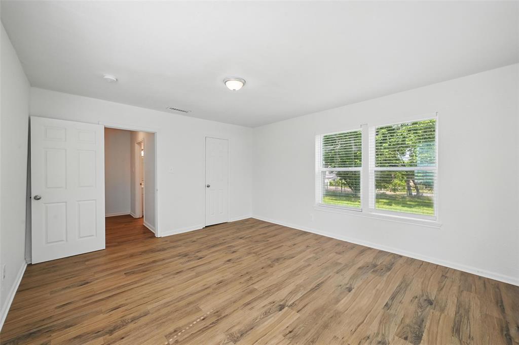 210 North 5th Avenue Denison, TX 75021 - Photo 14 of 20 a view of an empty room with wooden floor and a window