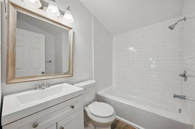 a bathroom with a sink a toilet and a bathtub