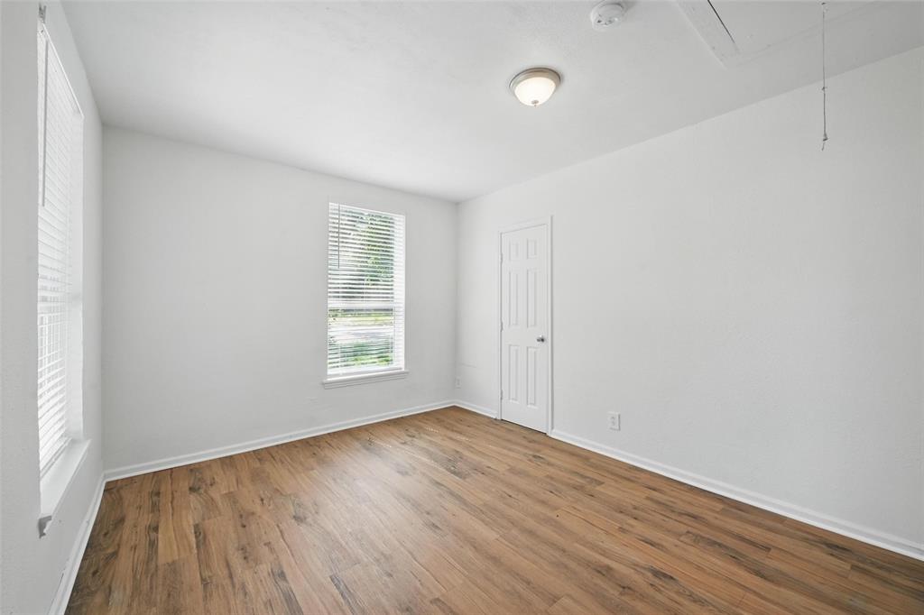210 North 5th Avenue Denison, TX 75021 - Photo 19 of 20 an empty room with wooden floor and windows