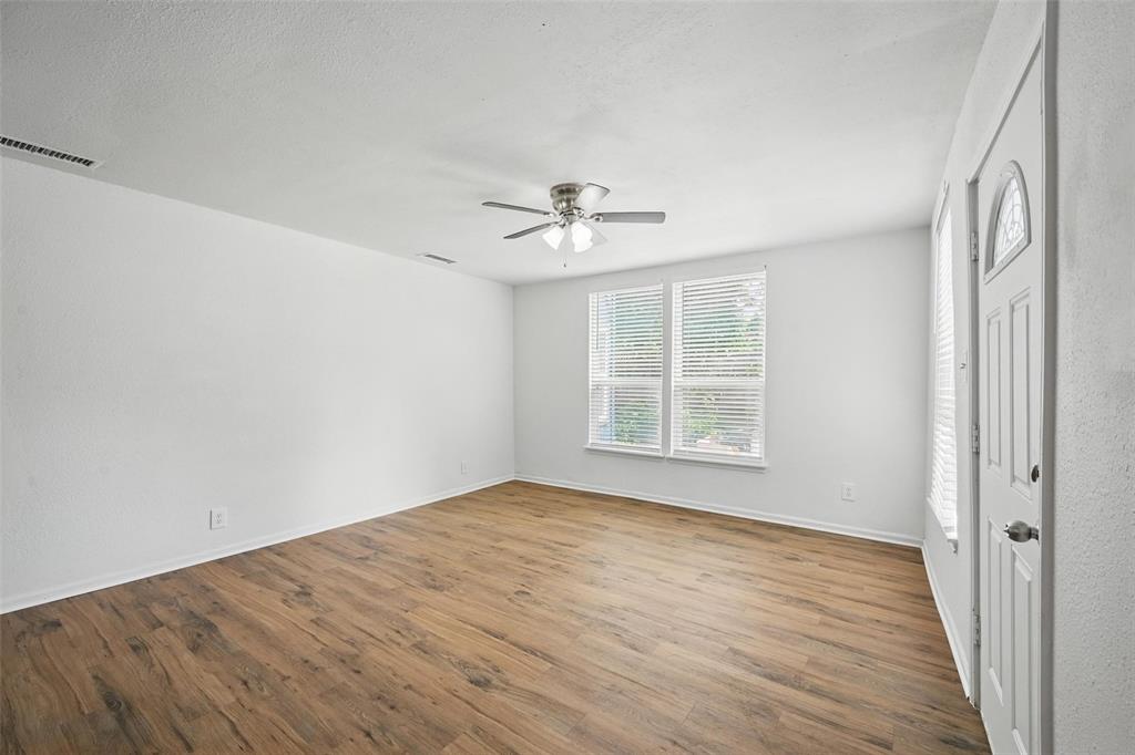 210 North 5th Avenue Denison, TX 75021 - Photo 4 of 20 wooden floor in an empty room with a window