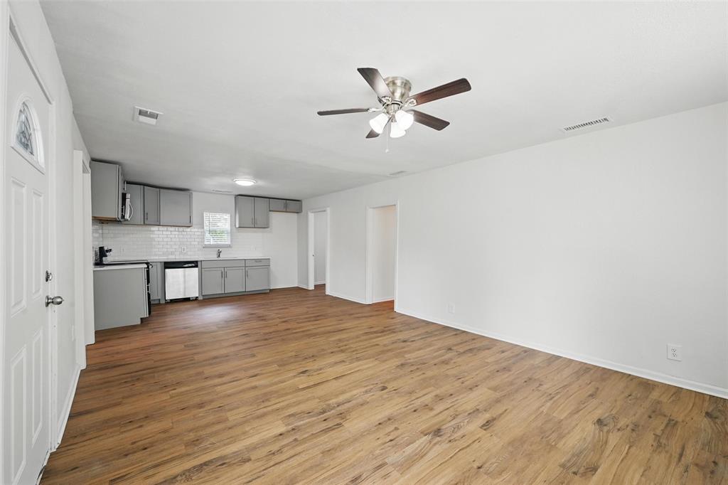 210 North 5th Avenue Denison, TX 75021 - Photo 6 of 20 a view of a kitchen with a sink and dishwasher with wooden floor