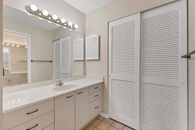 a bathroom with a toilet a sink and a large mirror