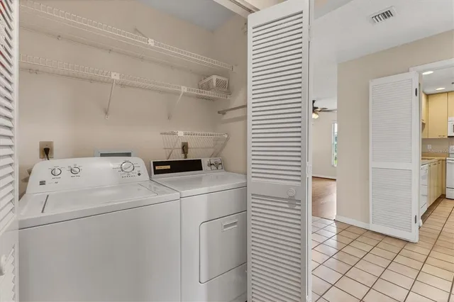 a view of a hallway view with wooden floor and a bathroom