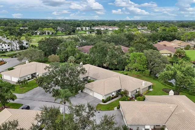a view of a house with a yard and potted plants