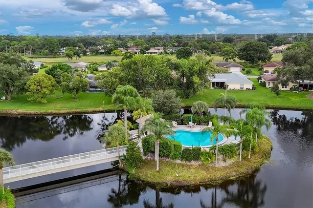 an aerial view of a house with garden space and street view