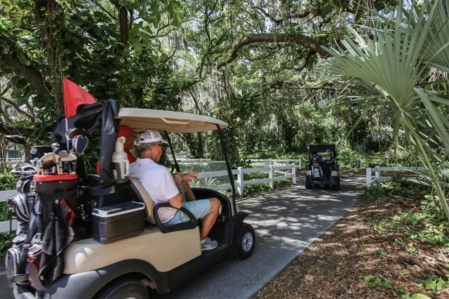 a view of a park with iron fence