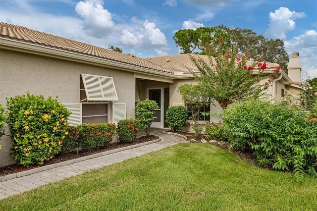 a view of an empty room with wooden floor and a fireplace