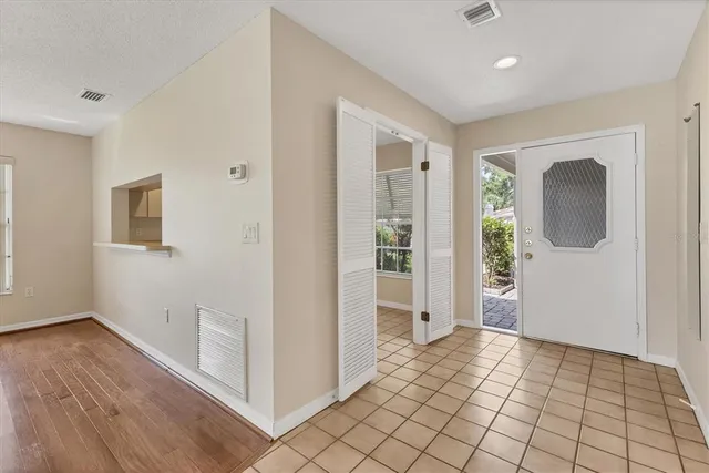 a view of empty room with wooden floor and fireplace