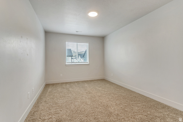 4572 Flower Point Eagle Mountain, UT 84005 - Photo 26 of 62 Bright interior space featuring light-toned carpeting and a window with horizontal blinds