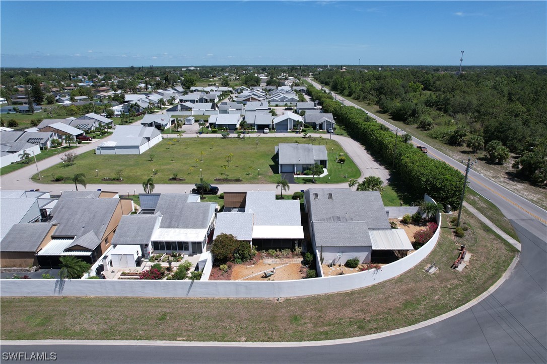 9805 Maplecrest Circle Lehigh Acres, FL 33936 - Photo 12 of 38 an aerial view of a house with a garden