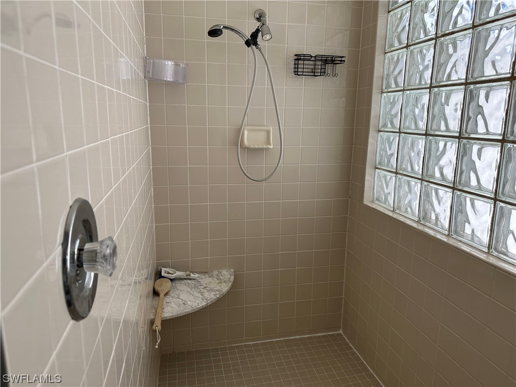 9805 Maplecrest Circle Lehigh Acres, FL 33936 - Photo 13 of 38 a bathroom with a shower