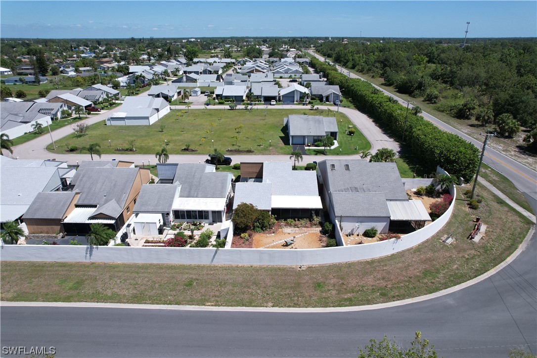 9805 Maplecrest Circle Lehigh Acres, FL 33936 - Photo 14 of 38 an aerial view of residential houses with outdoor space and parking