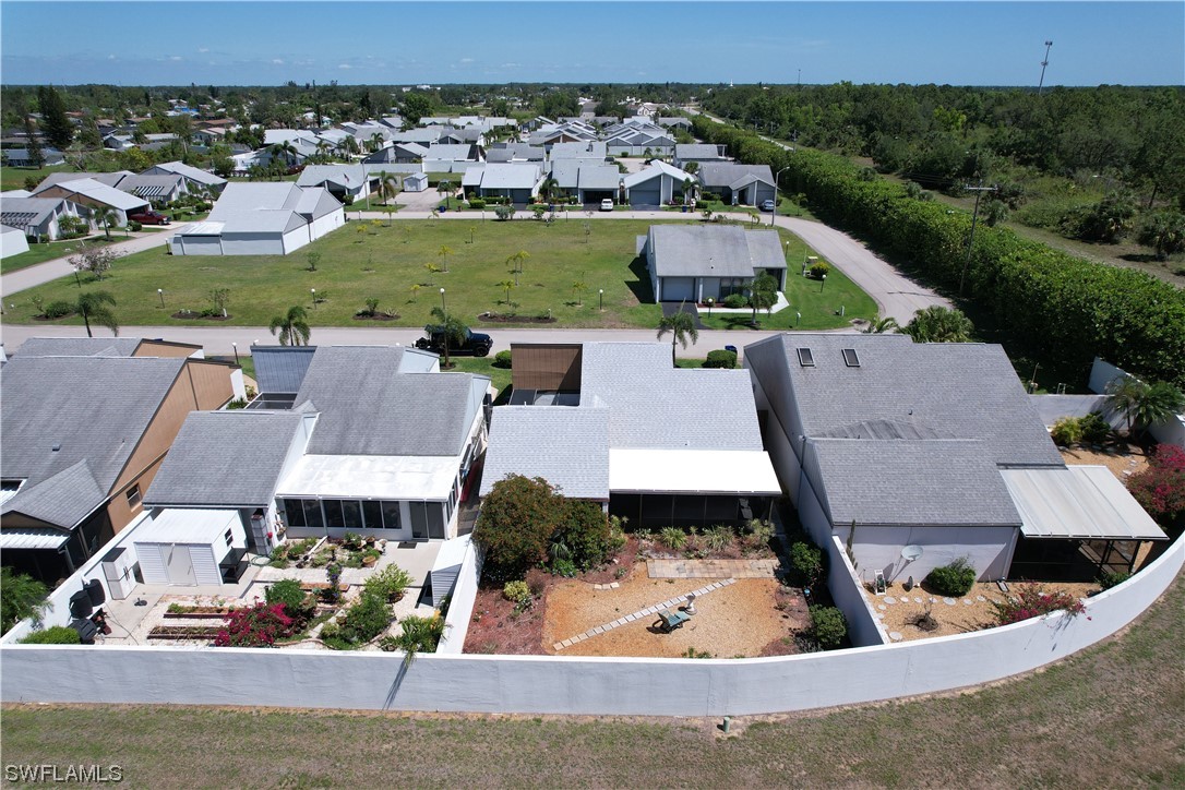 9805 Maplecrest Circle Lehigh Acres, FL 33936 - Photo 16 of 38 an aerial view of a house with a yard