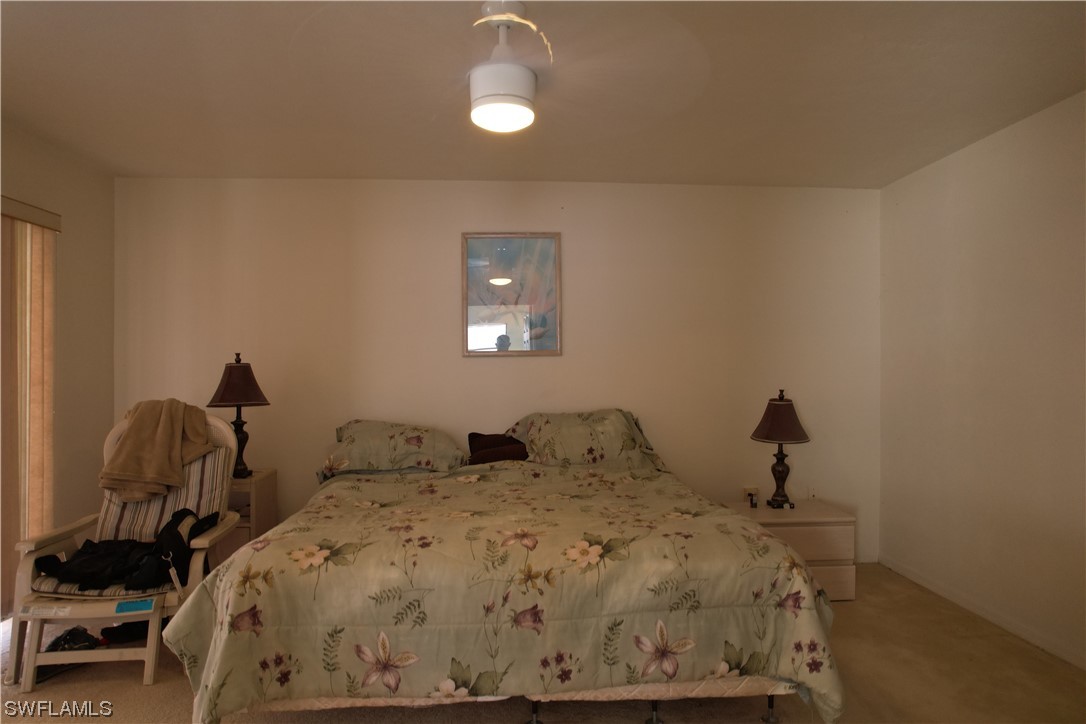 9805 Maplecrest Circle Lehigh Acres, FL 33936 - Photo 17 of 38 a bedroom with a bed and window