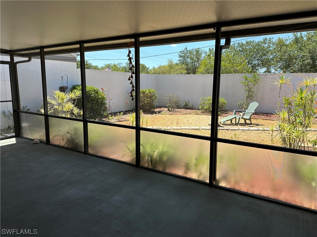 9805 Maplecrest Circle Lehigh Acres, FL 33936 - Photo 18 of 38 a view of an empty room with a floor to ceiling window
