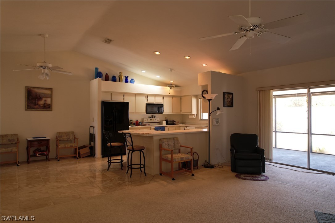 9805 Maplecrest Circle Lehigh Acres, FL 33936 - Photo 23 of 38 a living room with furniture a flat screen tv and a large window