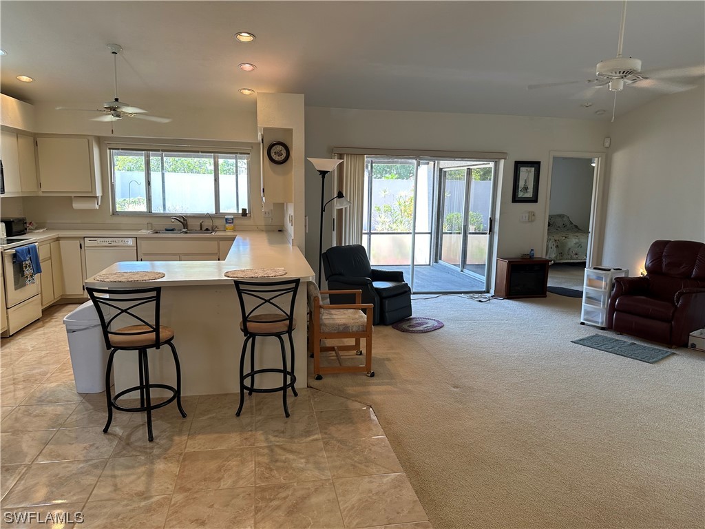 9805 Maplecrest Circle Lehigh Acres, FL 33936 - Photo 25 of 38 a living room with furniture and a window
