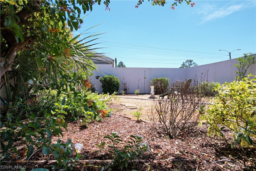 9805 Maplecrest Circle Lehigh Acres, FL 33936 - Photo 27 of 38 a view of a garden