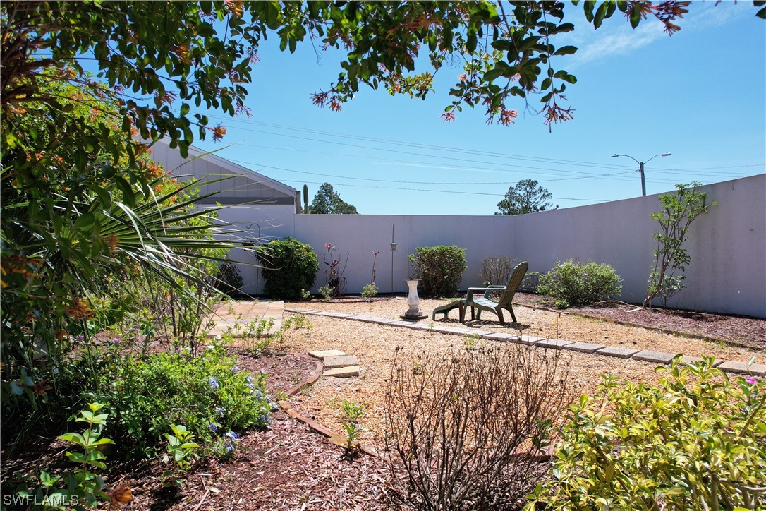 9805 Maplecrest Circle Lehigh Acres, FL 33936 - Photo 29 of 38 a view of a backyard of the house