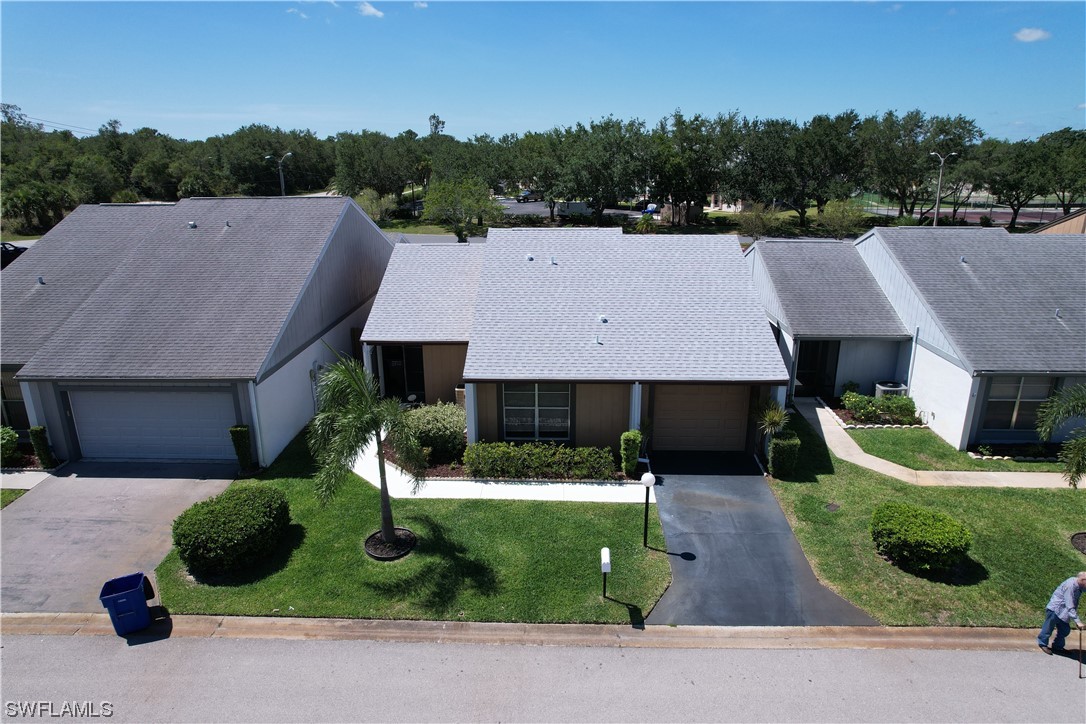 9805 Maplecrest Circle Lehigh Acres, FL 33936 - Photo 3 of 38 a aerial view of a house next to a yard