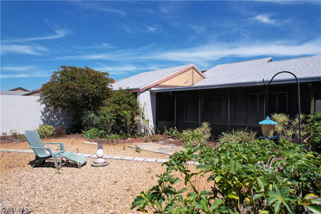 9805 Maplecrest Circle Lehigh Acres, FL 33936 - Photo 31 of 38 a front view of a house with sitting area