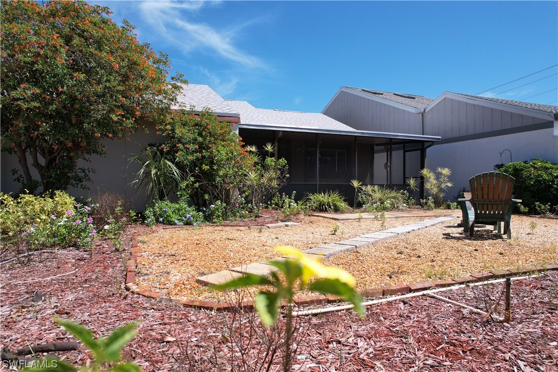 9805 Maplecrest Circle Lehigh Acres, FL 33936 - Photo 36 of 38 a view of a house with backyard and sitting area