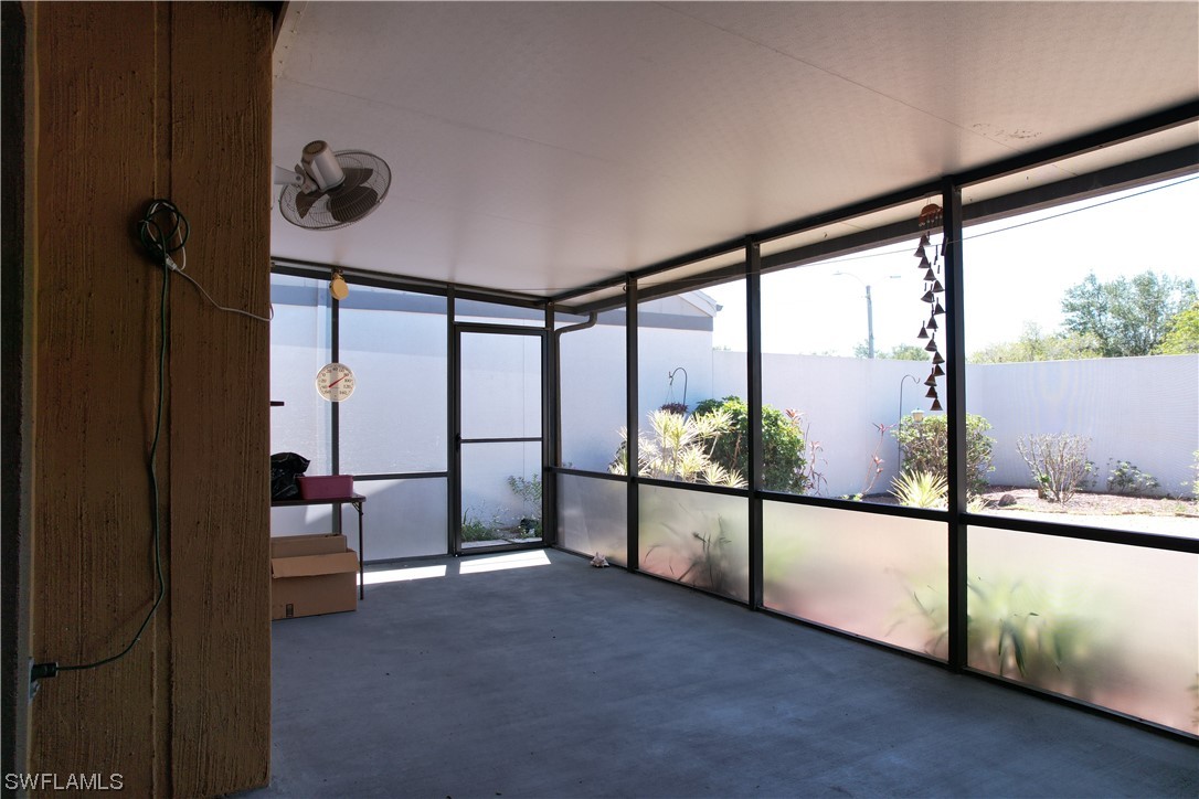 9805 Maplecrest Circle Lehigh Acres, FL 33936 - Photo 37 of 38 a view of an empty room with floor to ceiling window