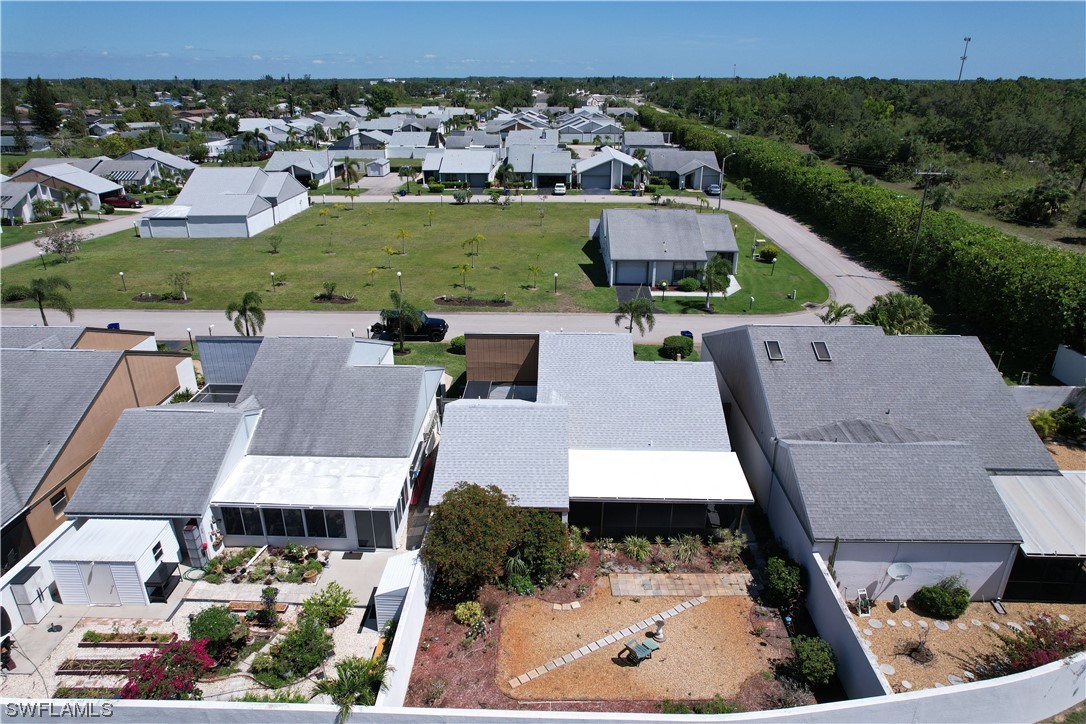 9805 Maplecrest Circle Lehigh Acres, FL 33936 - Photo 5 of 38 an aerial view of a house with a garden