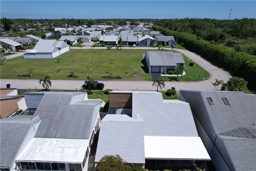 9805 Maplecrest Circle Lehigh Acres, FL 33936 - Photo 7 of 38 an aerial view of a house with a yard