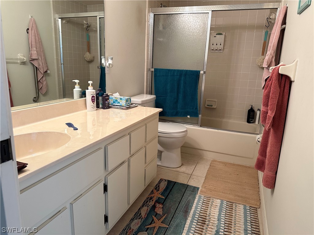 9805 Maplecrest Circle Lehigh Acres, FL 33936 - Photo 9 of 38 a bathroom with a sink a toilet a mirror and shower